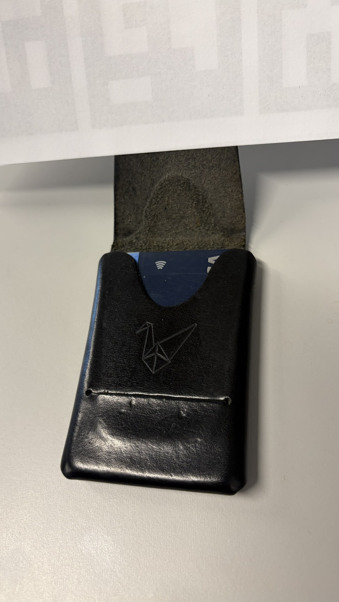 Open wallet showing interior pocket and embossed crane logo