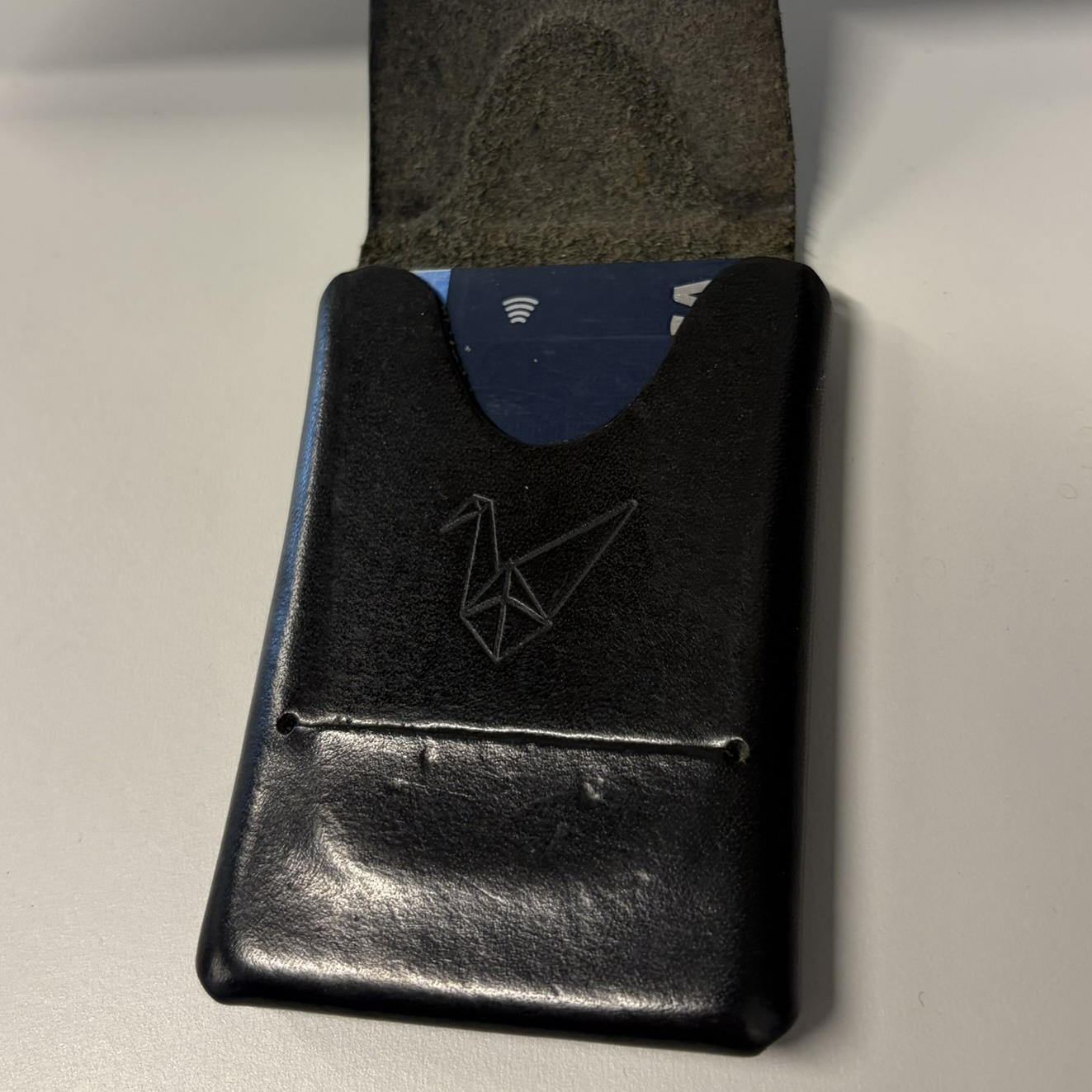 Open wallet showing interior pocket and embossed crane logo